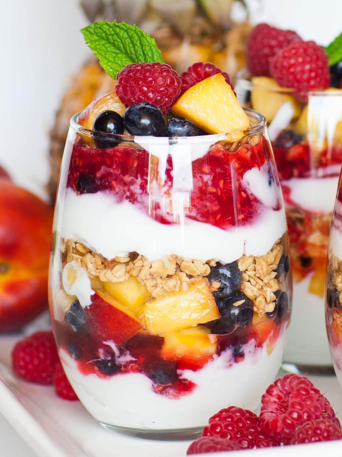 Vibrant fruit parfait served in a clear glass showcasing layers of yogurt, fruits, and granola