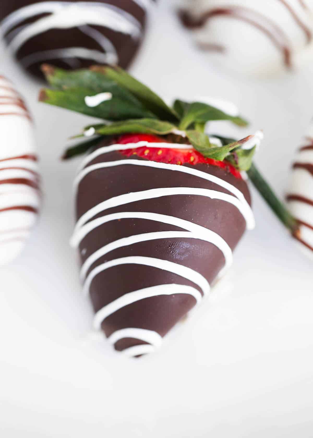 Delicious chocolate covered strawberries on a white plate